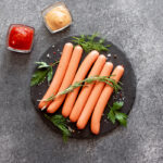Raw,Sausages,On,Stone,Background