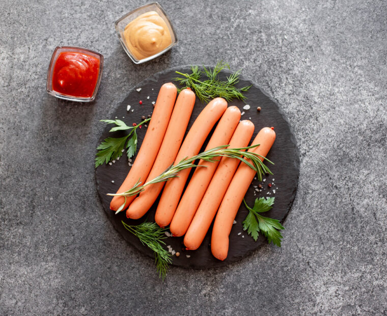 Raw,Sausages,On,Stone,Background