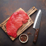 Raw,Uncooked,Top,Round,Beef,Steak,On,Wooden,Cutting,Board
