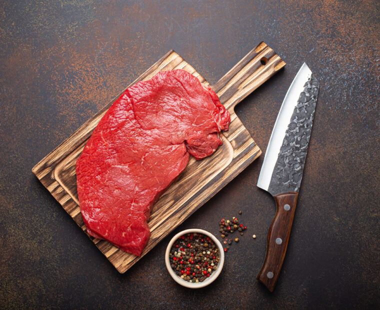 Raw,Uncooked,Top,Round,Beef,Steak,On,Wooden,Cutting,Board