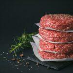Raw,Ground,Beef,Burger,Patties,Separated,By,Baking,Paper,On