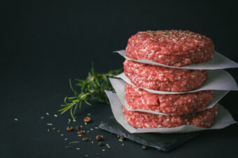 Raw,Ground,Beef,Burger,Patties,Separated,By,Baking,Paper,On