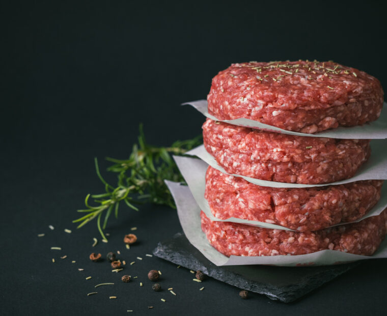 Raw,Ground,Beef,Burger,Patties,Separated,By,Baking,Paper,On