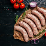 Raw,Sausages,With,Spices,And,Rosemary,On,Cutting,Board.,Cooking