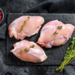 Raw,Boneless,Chicken,Thighs,Fillet.,Black,Background.,Top,View