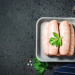 Raw,Sausages,With,Herbs,,Spices,,Herbs,On,Dark,Background.,Top