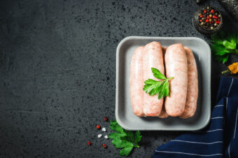 Raw,Sausages,With,Herbs,,Spices,,Herbs,On,Dark,Background.,Top