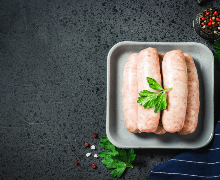 Raw,Sausages,With,Herbs,,Spices,,Herbs,On,Dark,Background.,Top