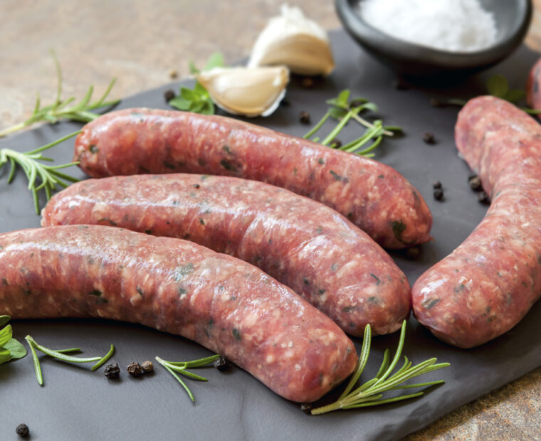 Raw,Sausages,On,Slate,,With,Herbs,And,Spices.,Side,View.