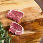 Raw,Lamb,Loin,Slices,On,Chopping,Board,With,Herbs