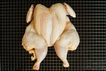 Whole,Raw,Chicken,On,Metal,Rack