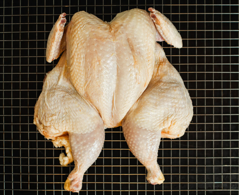 Whole,Raw,Chicken,On,Metal,Rack