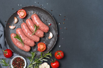 Raw,Sausages,Or,Bratwurst,With,Ingredients,For,Cooking,On,Black