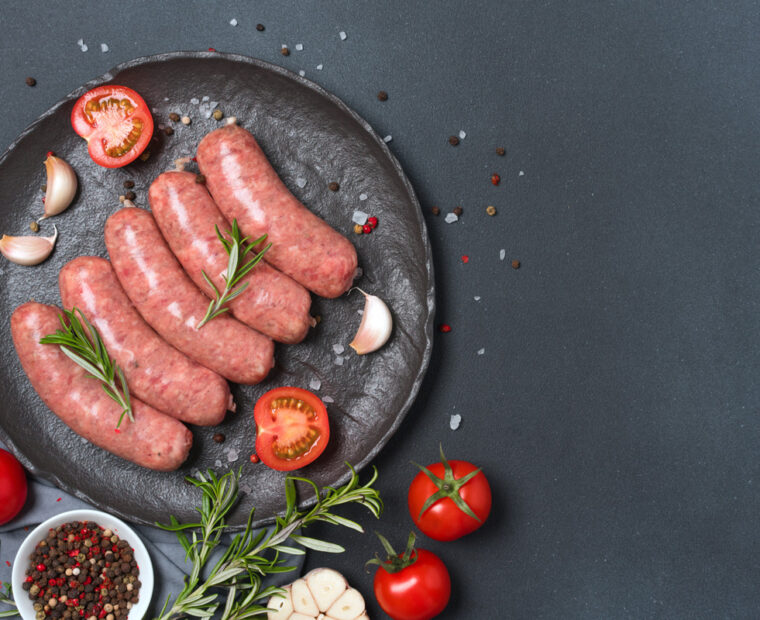 Raw,Sausages,Or,Bratwurst,With,Ingredients,For,Cooking,On,Black