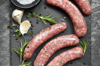 Raw,Sausages,On,Slate,,With,Herbs,And,Spices.,Overhead,View.